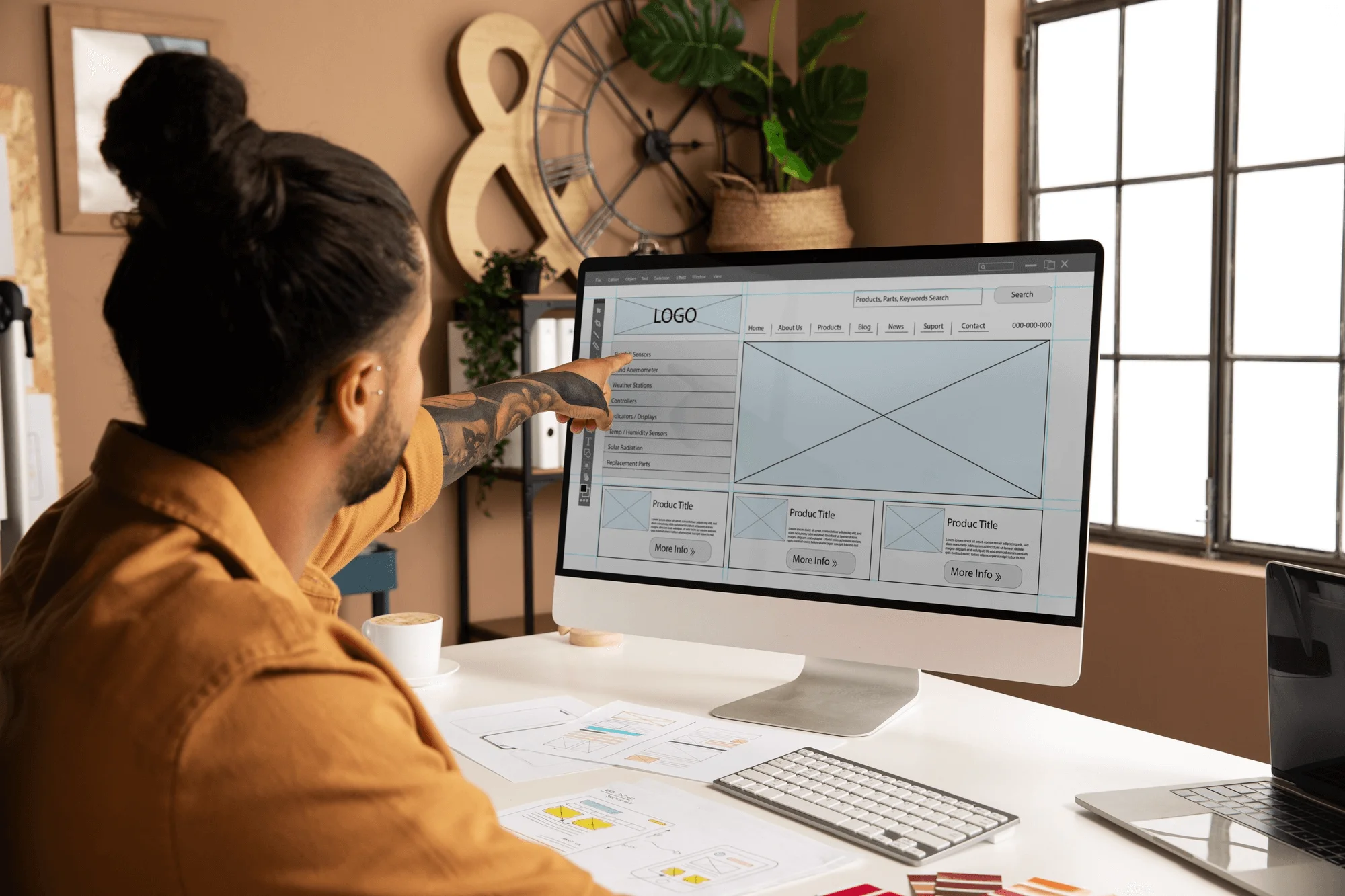 A man in the process of designing a website layout.