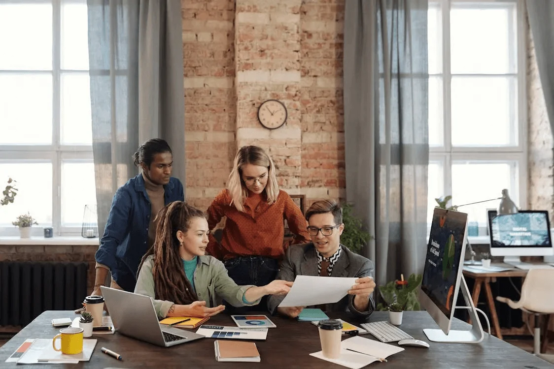 Diverse team discussing digital marketing strategies, showcasing collaboration in 360 digital marketing—a holistic approach to online branding and campaigns.